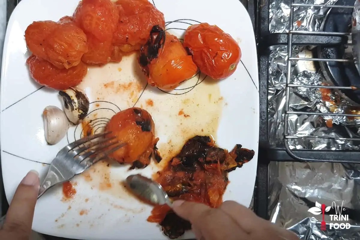 removing the charred skin from the tomatoes
