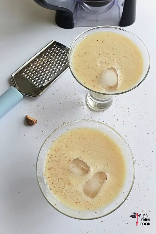 barbadine punch in two glasses with nutmeg and strainer