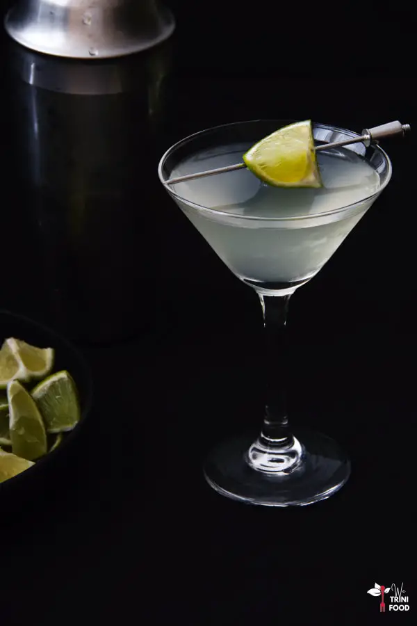 daiquiri in a martini glass with lime wedges as garnish and in a bowl