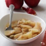 stewed apples ayurveda recipe with red apples and cloth in background