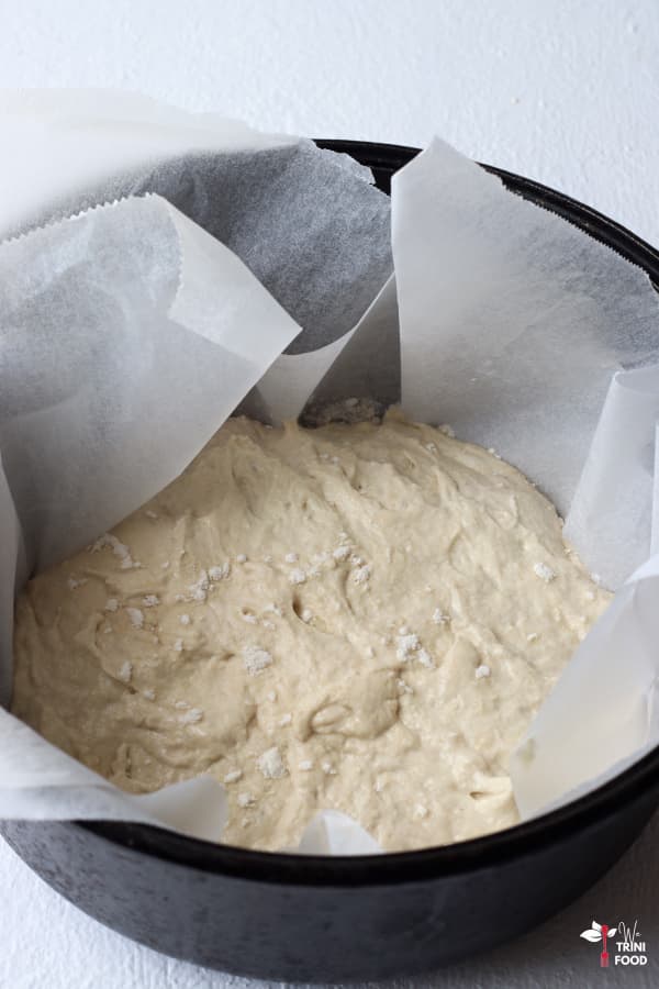 add parchment paper with dough to preheated dutch oven