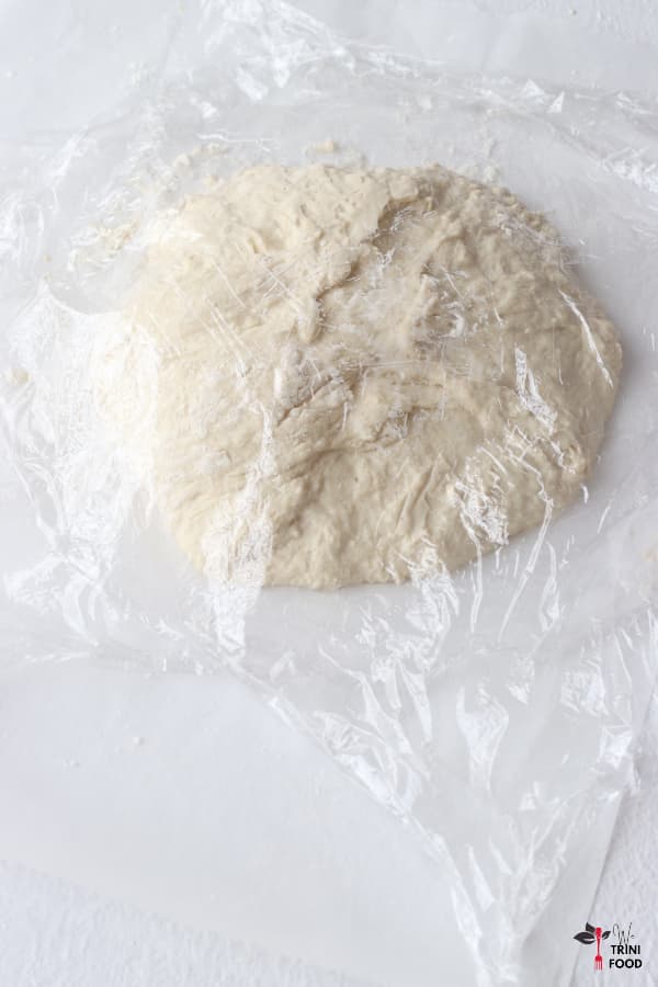 cover dough with plastic on parchment paper