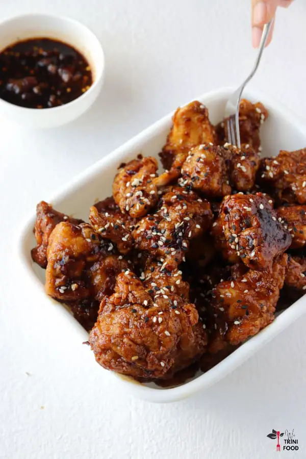 korean fried chicken bites with dipping sauce on the side