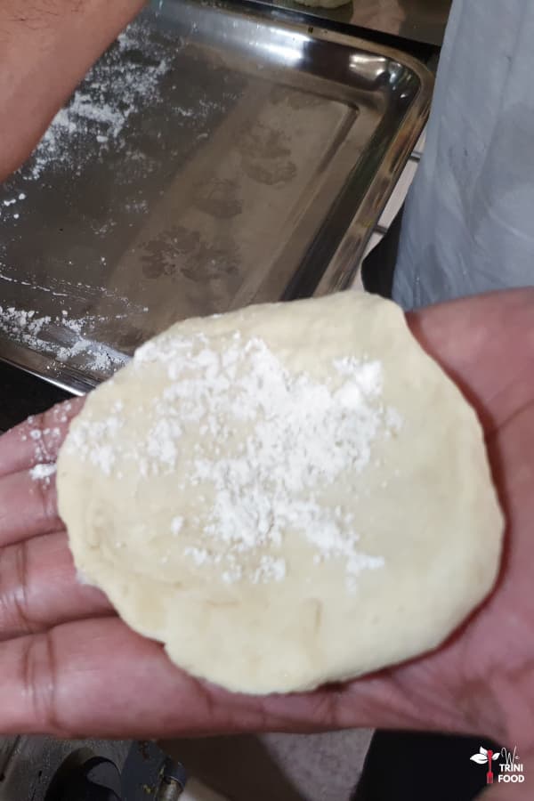 flattened dough with flour