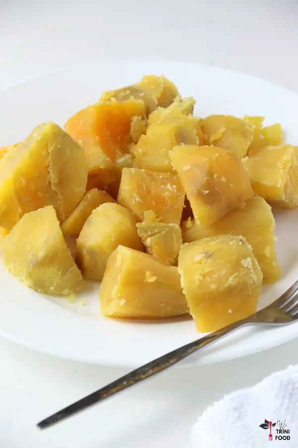 boiled sweet potatoes on white plate with fork