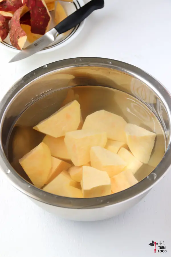 peeled sweet potato chunks in bowl with water