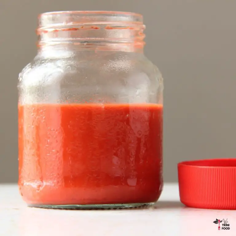 cold roucou sauce in glass bottle with red cover on the side
