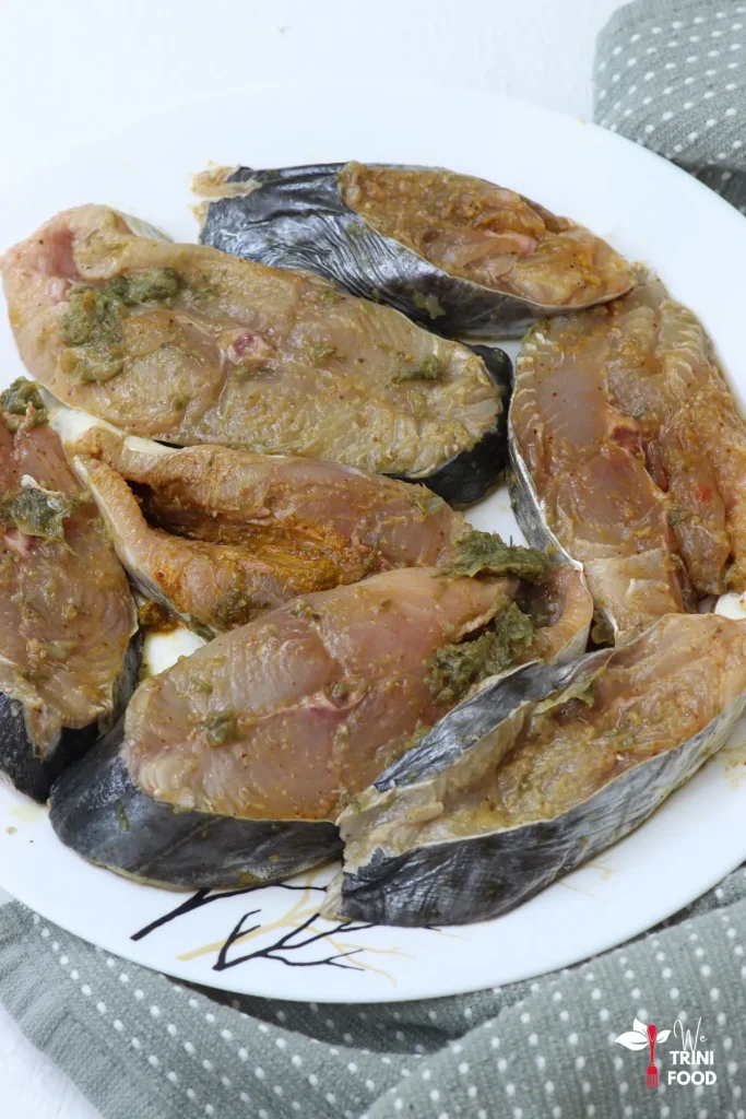 seasoned king fish with caribbean green seasoning and turmeric powder