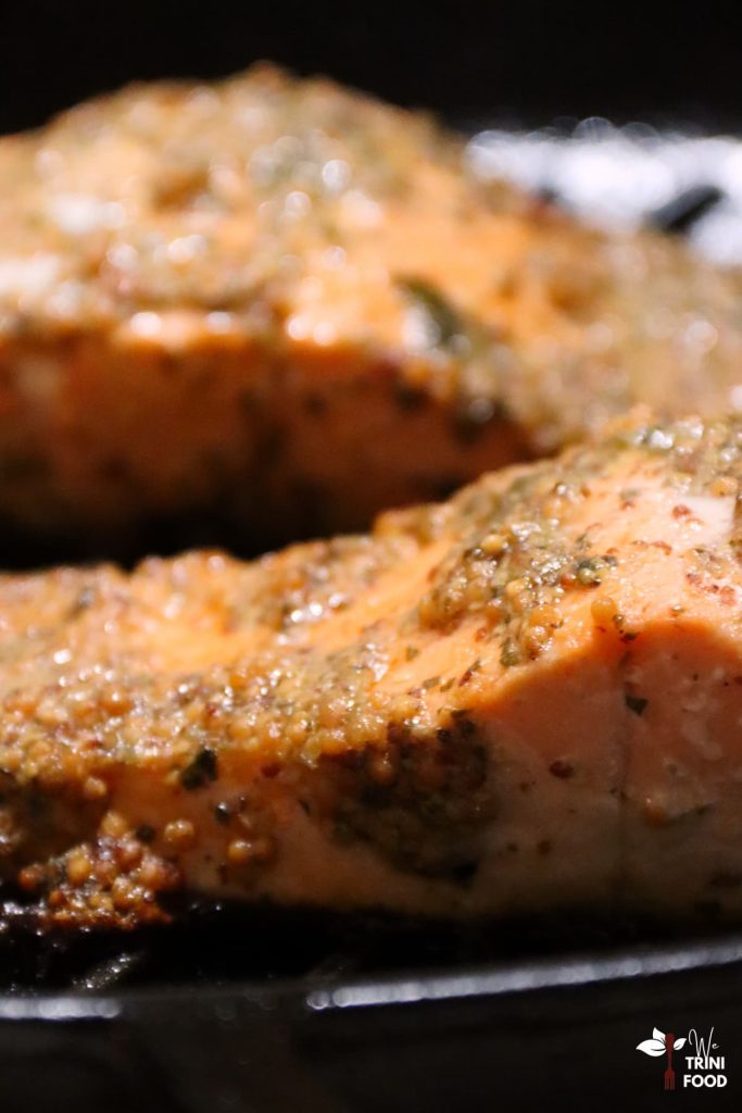 side view of cooked salmon seasoned with whole grain mustard, honey and Caribbean green seasoning