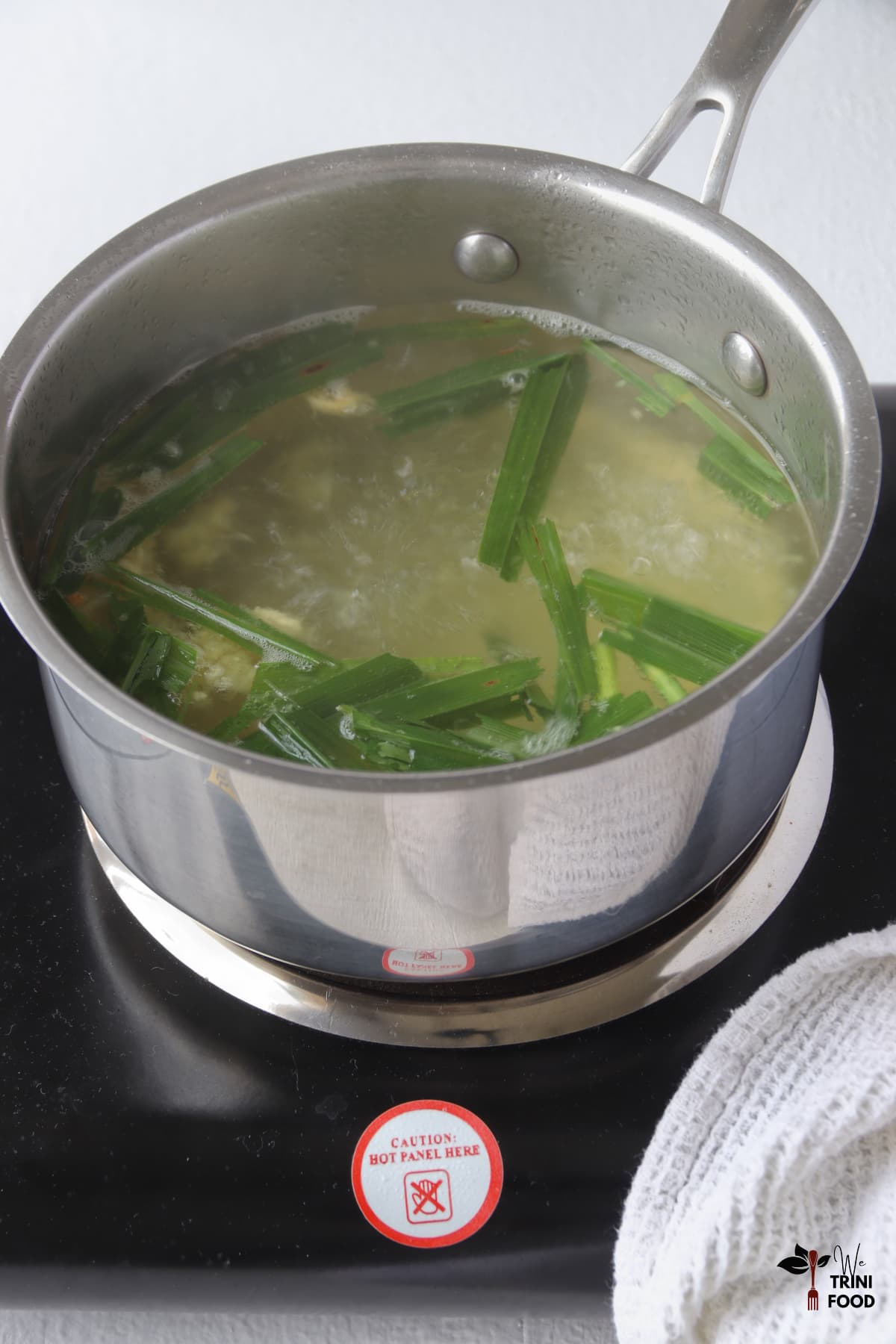boiling lemongrass ginger tea in saucepan