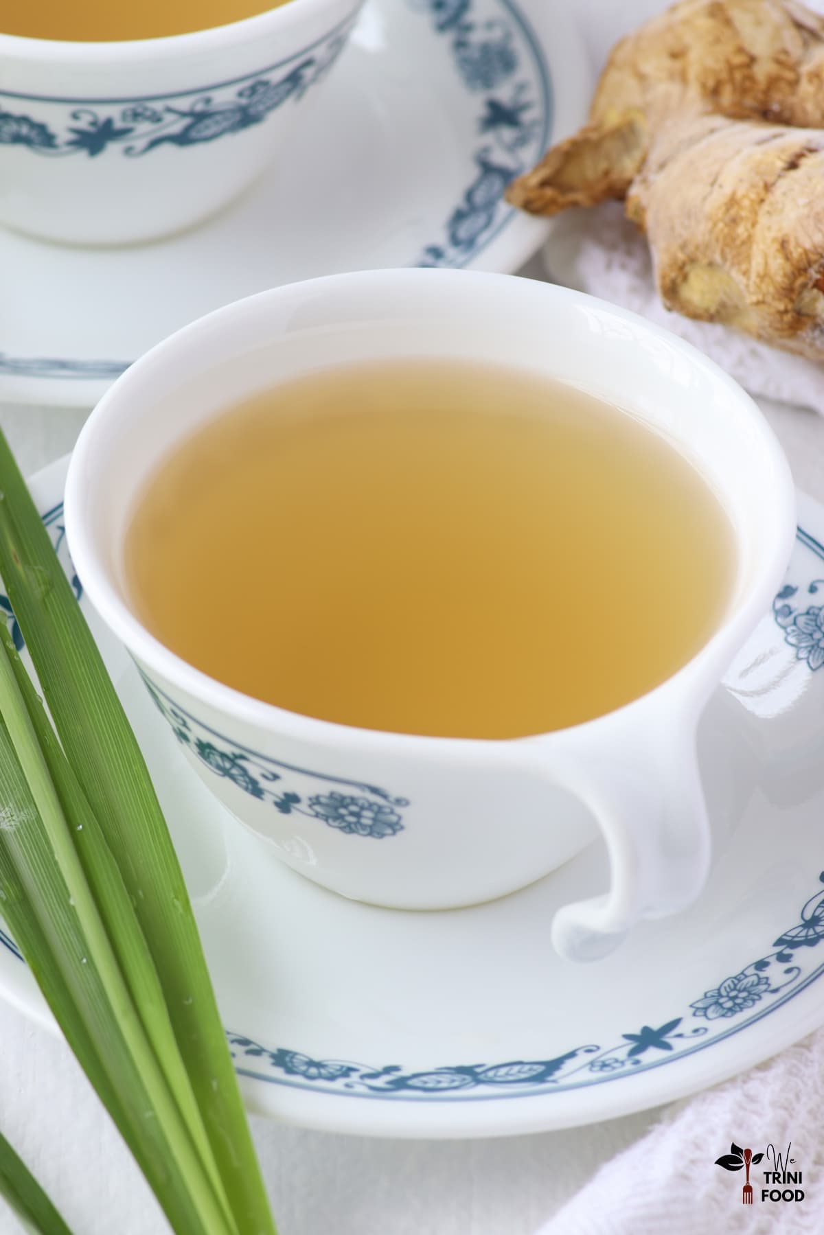 lemongrass ginger tea in white teacups with ingredients on the sides
