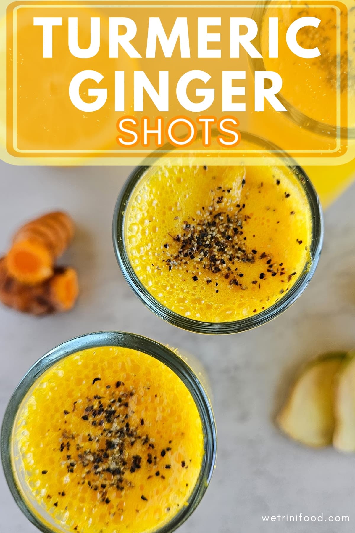 turmeric ginger shots text overlay on a photo of turmeric ginger shots with black pepper sprinkled on top