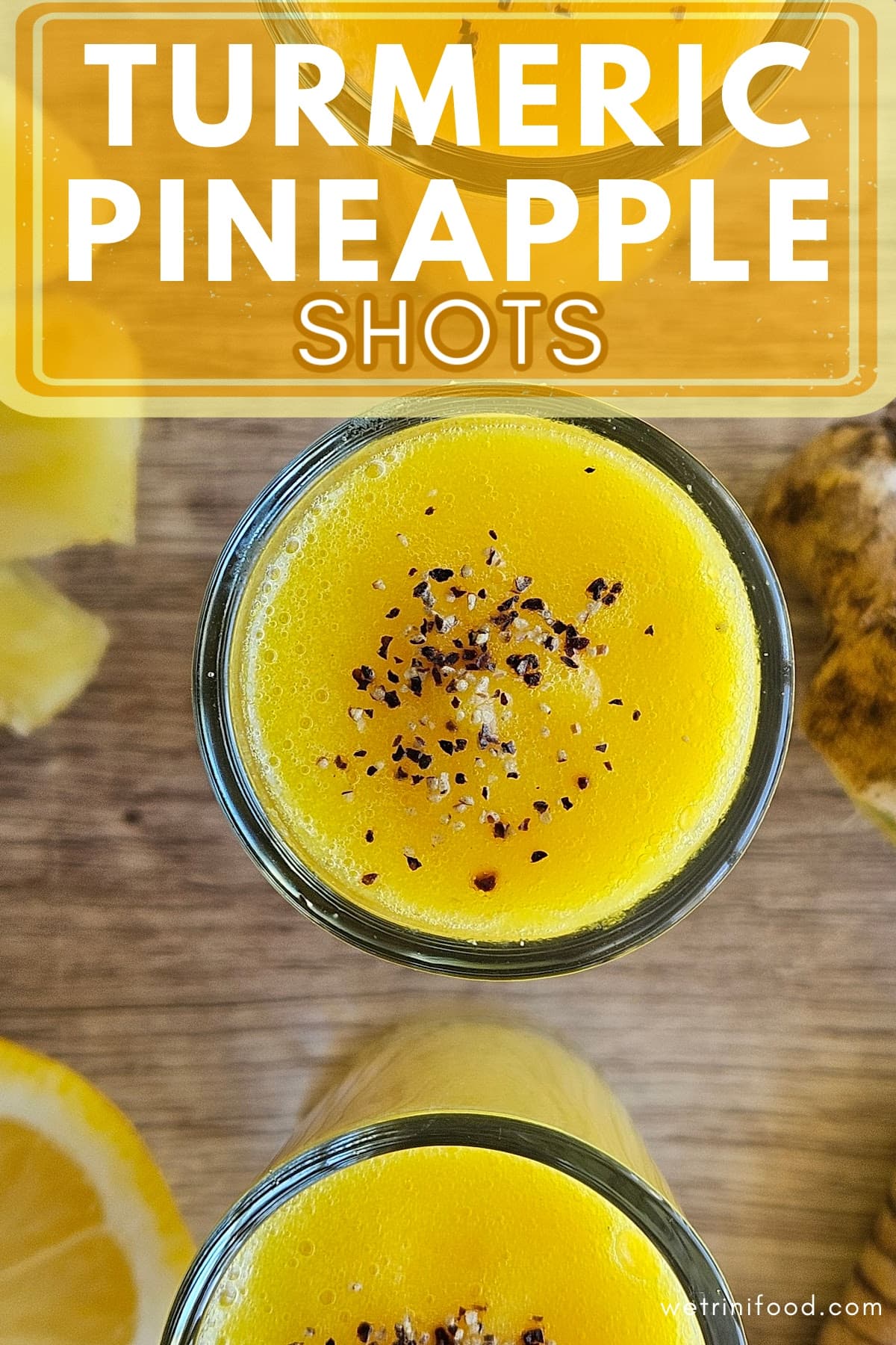 turmeric pineapple shots text overlay on a photo of turmeric pineapple shots with black pepper sprinkled on top