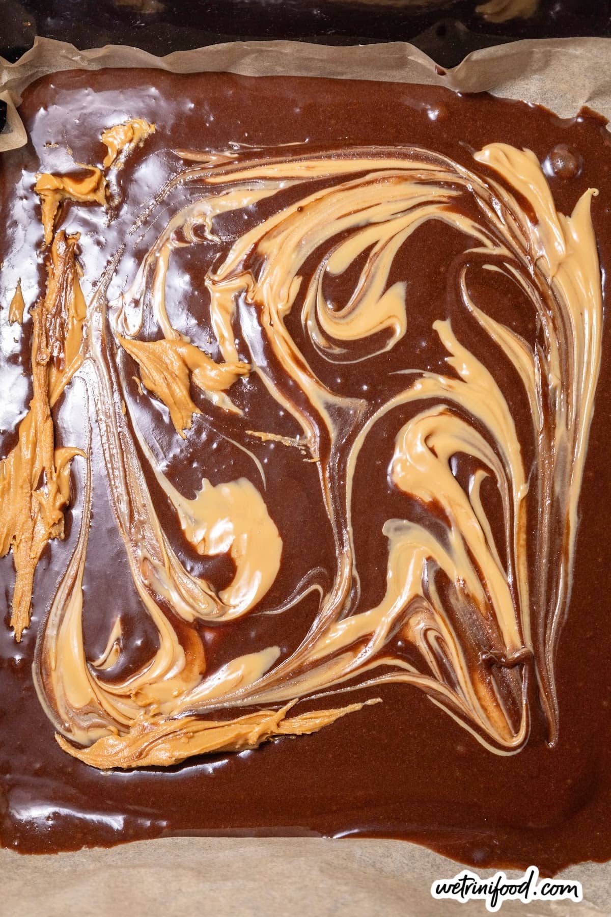 peanut butter swirls on brownie batter