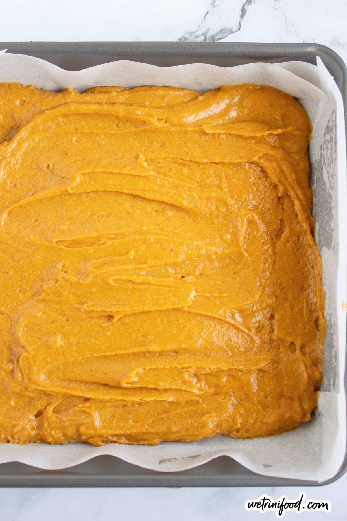 pumpkin blondies batter in baking dish