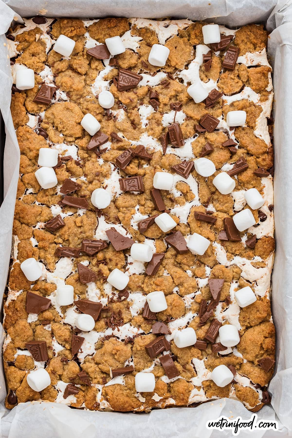 s'mores cookie bars with mini marshmallow and broken chocolate bar pieces
