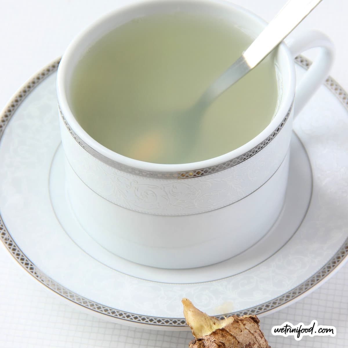 ginger tea in teacup with spoon and ginger on the side featured image