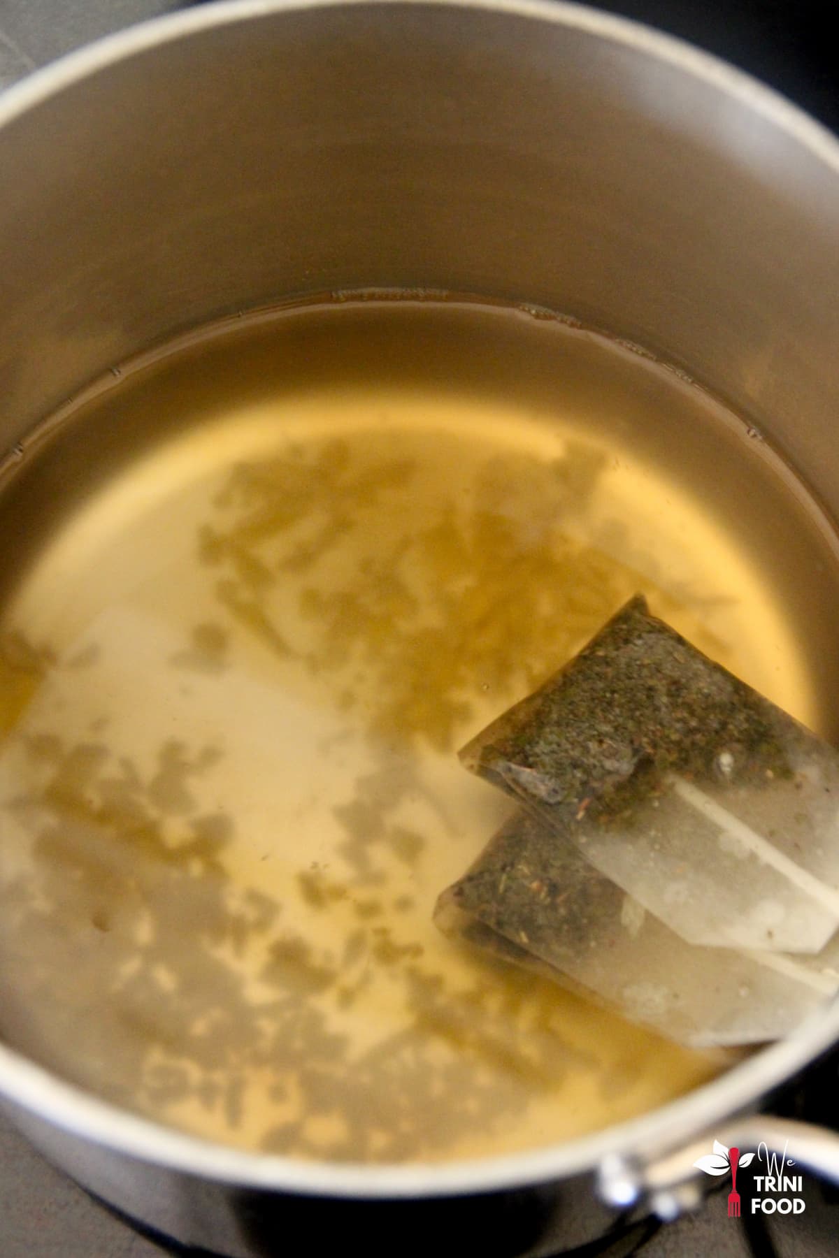 green tea teabags in ginger tea in saucepan