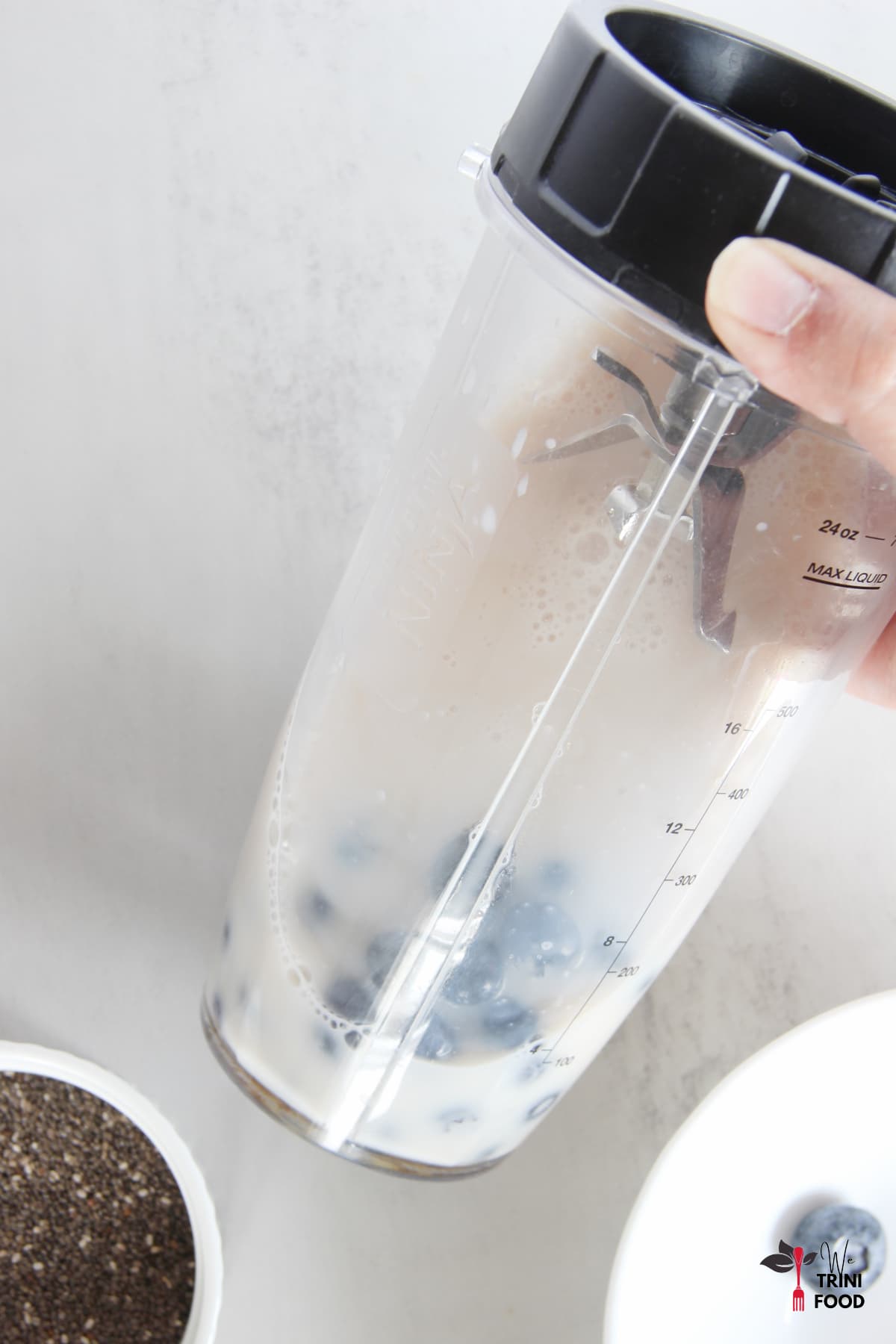 blueberries and milk in blender to make blueberry chia seed pudding
