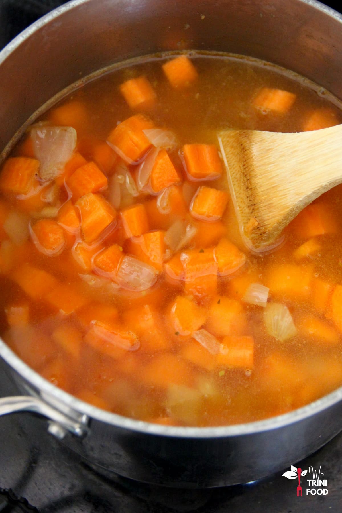 Adding carrots for vegan carrot ginger soup