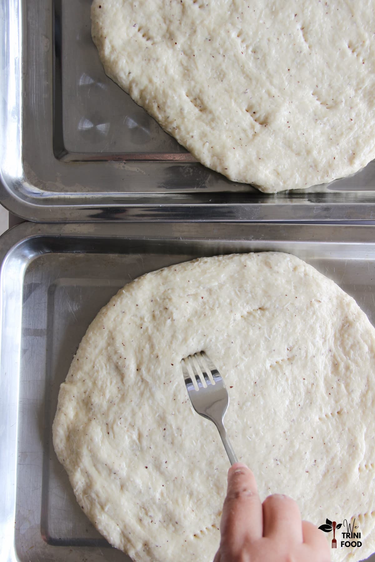 Rolled out coconut bakes and piercing them with a fork
